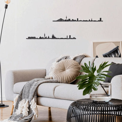 Decoración en la pared blanca destacan dos siluetas negras de skylines decorativos: Düsseldorf y Colonia /Köln