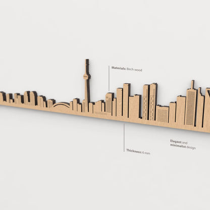 Vista en perspectiva de la silueta del skyline de Toronto en madera marrón.