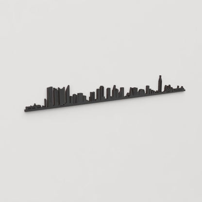 Vista en perspectiva de la silueta del skyline de Ciudad de México en madera negra.